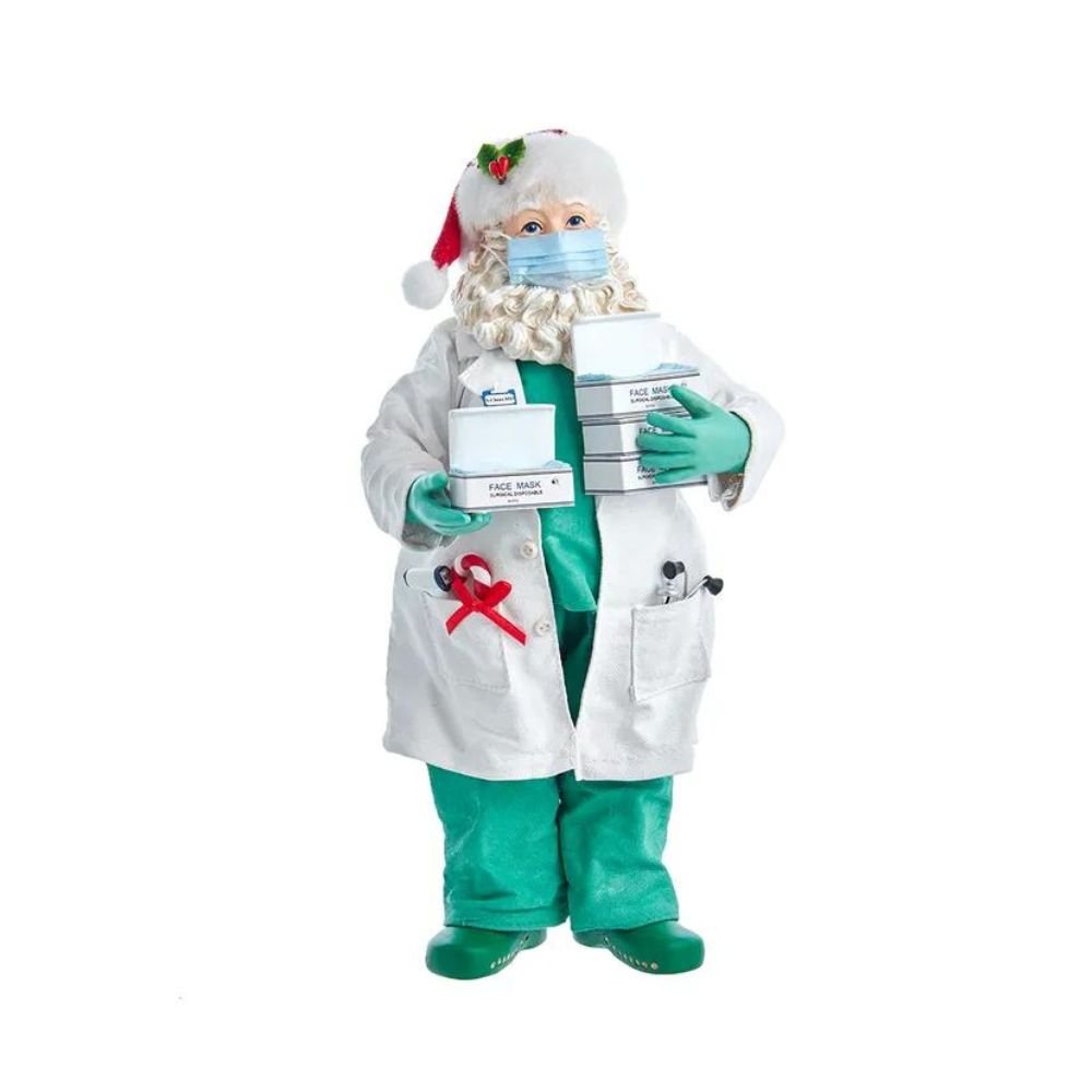 Holiday decoration featuring Fabriché™ Doctor Santa Holding Face Masks, 10.5 Inches