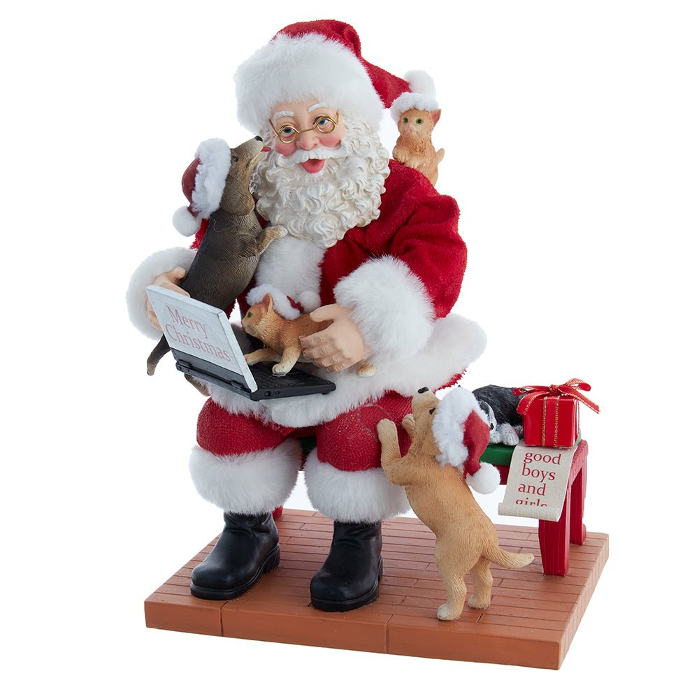Holiday decoration featuring Fabriché™ Santa Figurine With Laptop and Pets, 9 inches