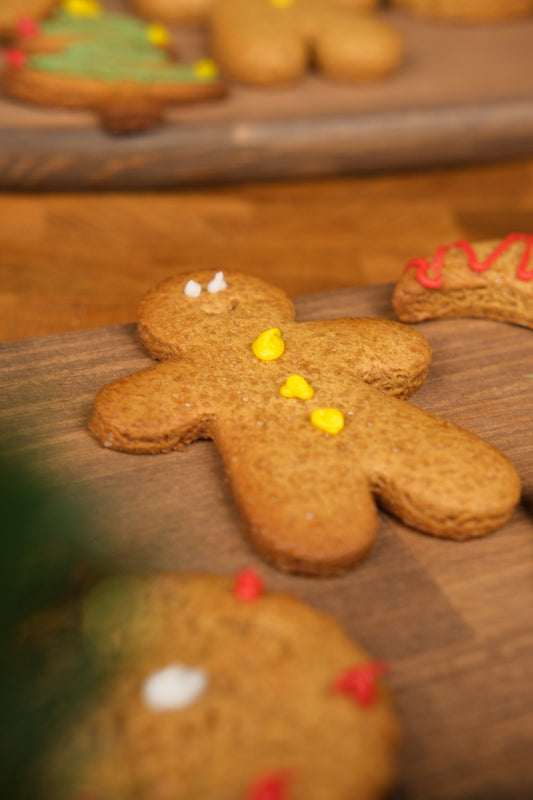 Gingerbread man cookies on a wooden surface.