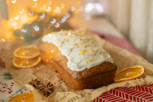 Iced loaf cake with dried orange slices and spices